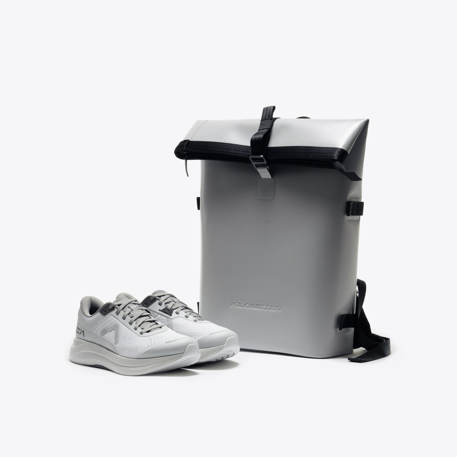 Urban Running Kit: gray running shoes and a roll-top backpack