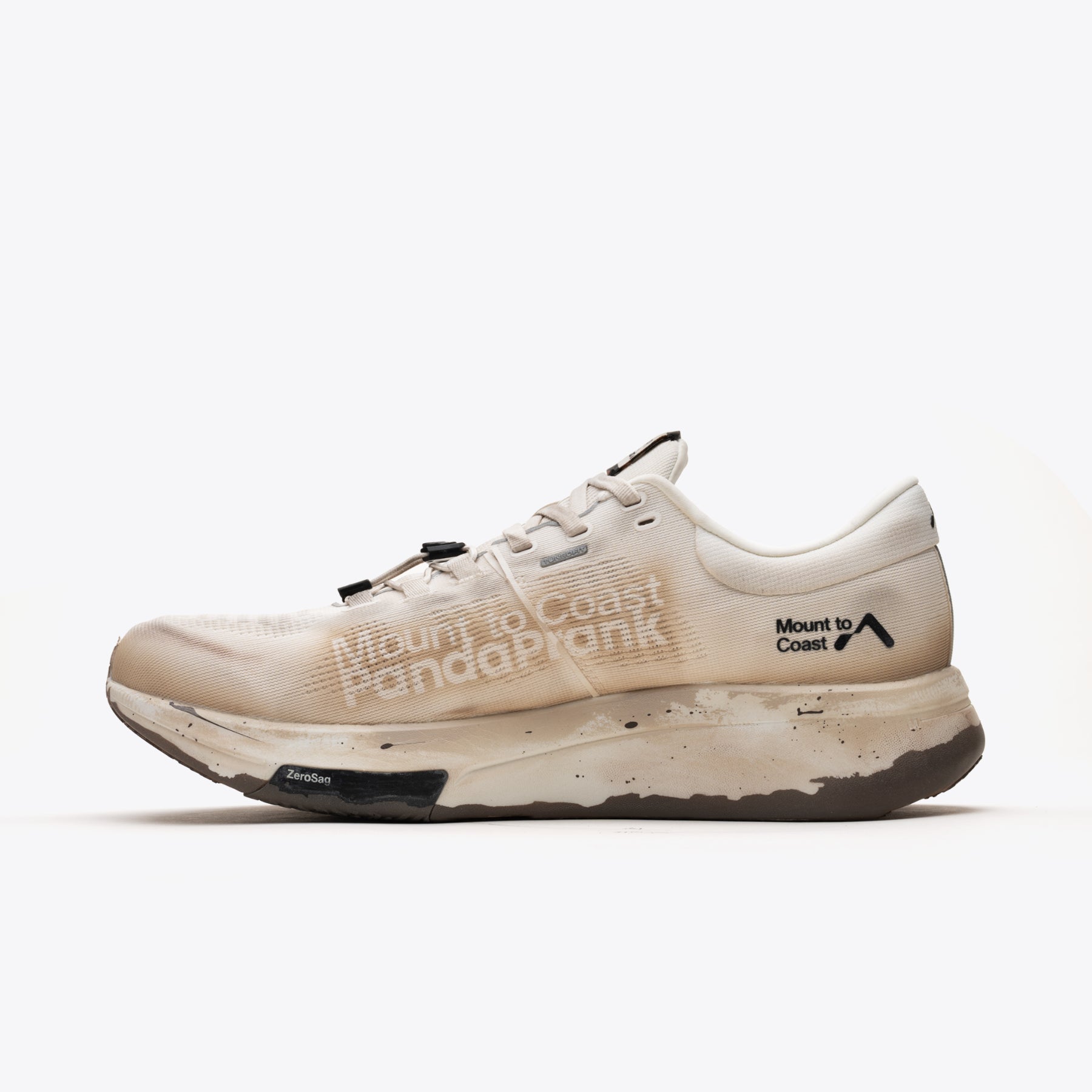 R1 Legacy trail running shoe, tan color, 'Mount to Coast' branding, designed for trail and ultrarunners, durable design.