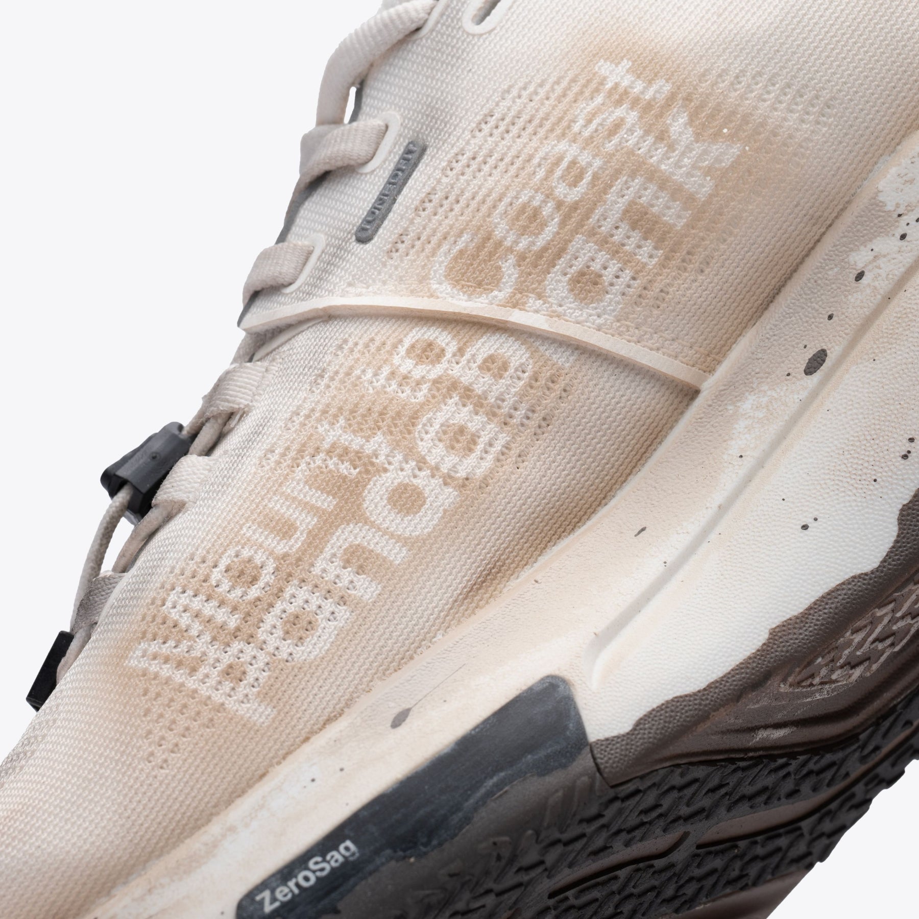 R1 Legacy trail shoe. Tan and cream colorway, Mount to Coast branding, ZeroSag. Designed for ultrarunners.