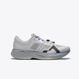 R135 ultra-marathon running shoe in white with blue laces and grey sole. Featuring LightCELL midsole for optimal performance.