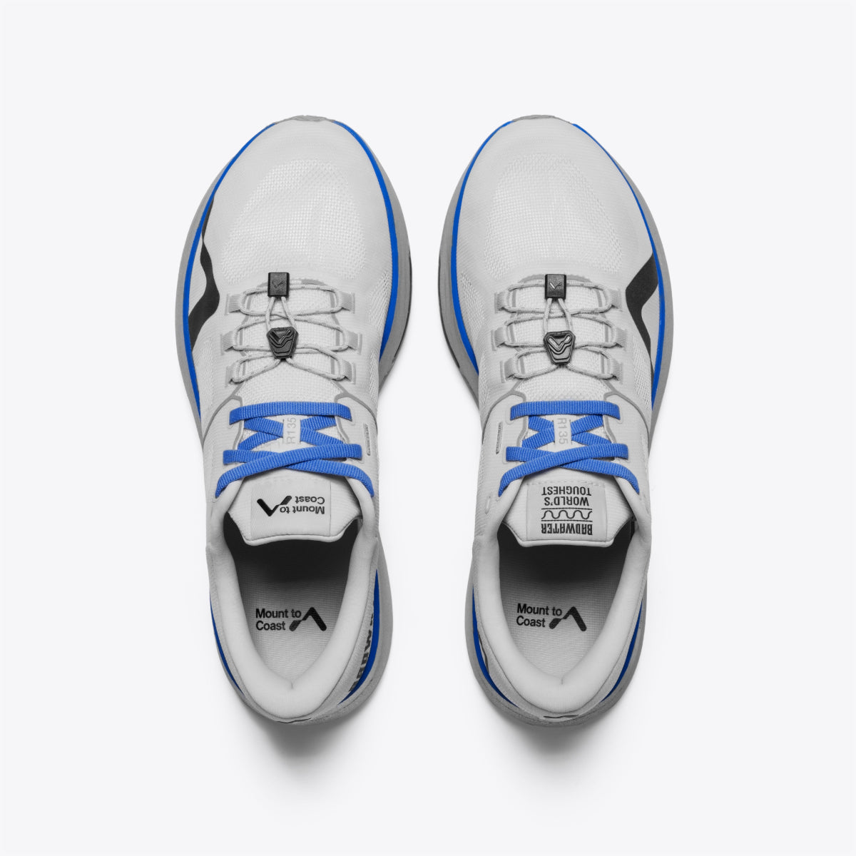 R135 ultra-marathon running shoe, white with blue details, grey sole. Dual lacing system, breathable mesh, Mount to Coast.