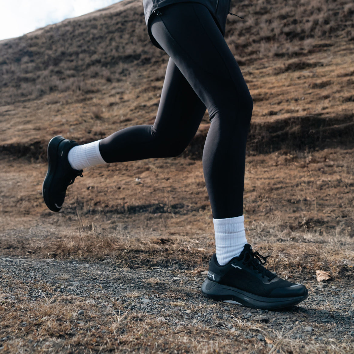 Runner wearing Mount to Coast S1 black running shoe #Color_black