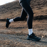 Runner wearing Mount to Coast S1 black running shoe #Color_black