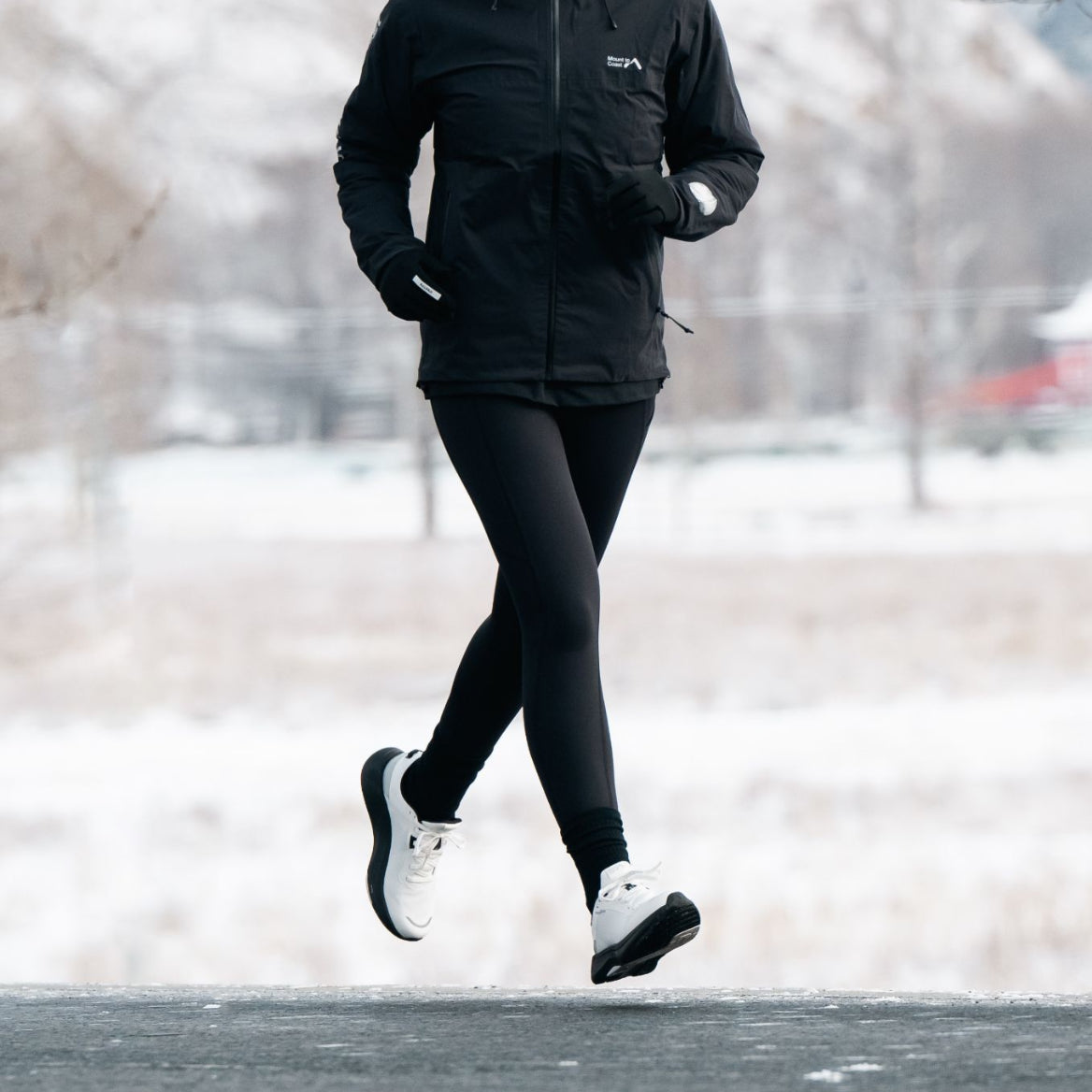 Runner wearing Mount to Coast S1 running shoes in snowy weather #Color_white|black