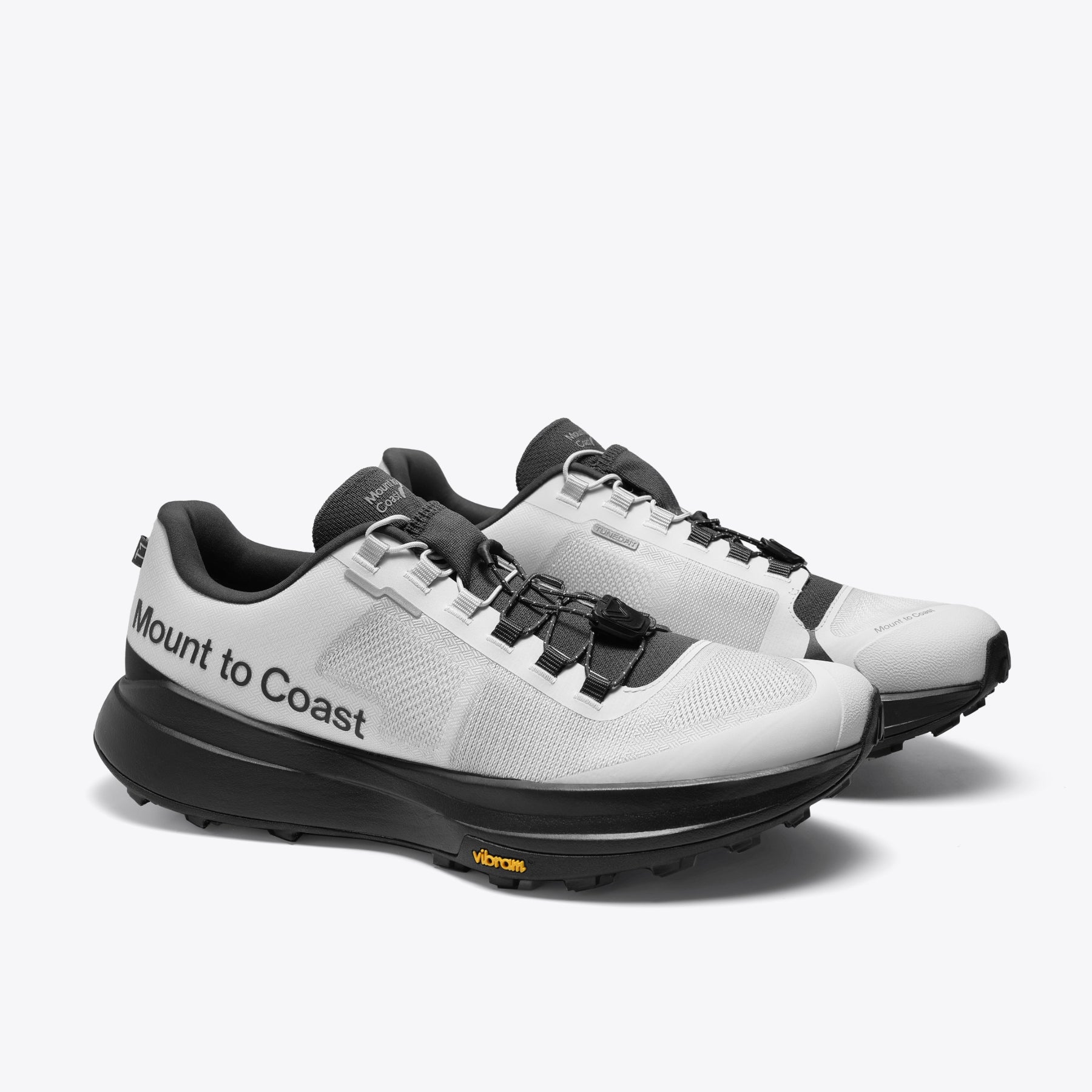 Mount to Coast T1 trail running shoes, white and black colorway, Vibram sole, for long-distance trail adventures.
#Color_tephra