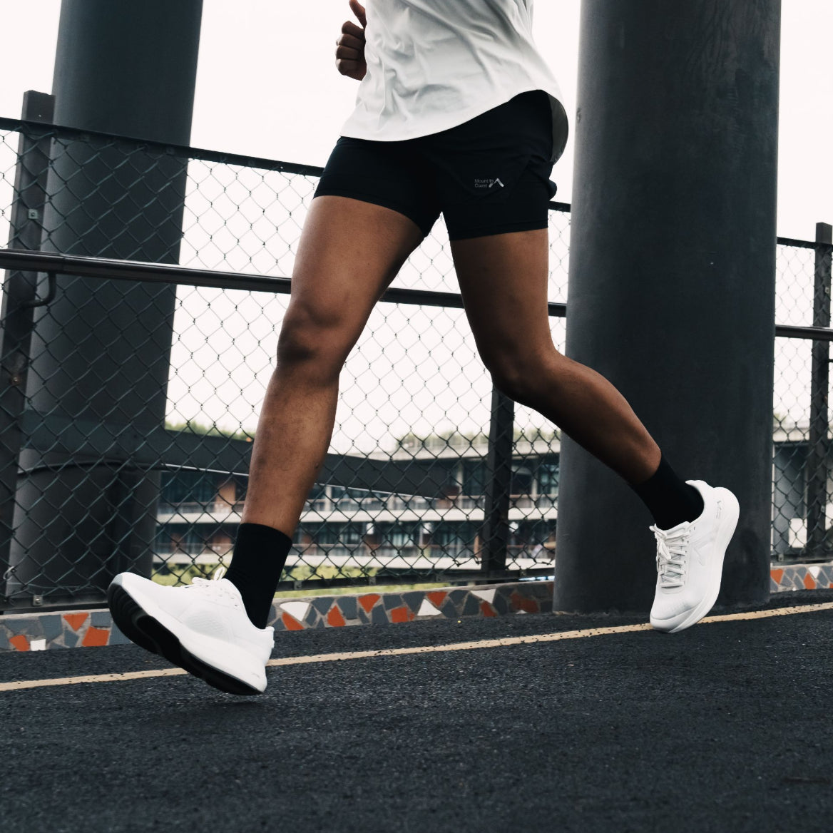 Runner in white Mount to Coast shoes, ideal for road running #Color_white