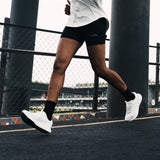 Runner in white Mount to Coast shoes, ideal for road running #Color_white
