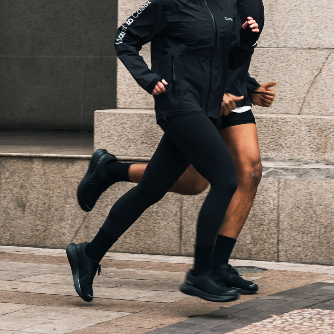 Runners in action wearing Mount to Coast gear and shoes #Color_black