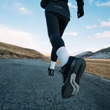 Runner wearing Mount to Coast R1 shoes on road #Color_black
