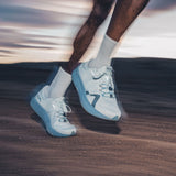 Mount to Coast R1 running shoe in light blue, LightCELL tech, for ultramarathons. Runner in action. #Color_twilight