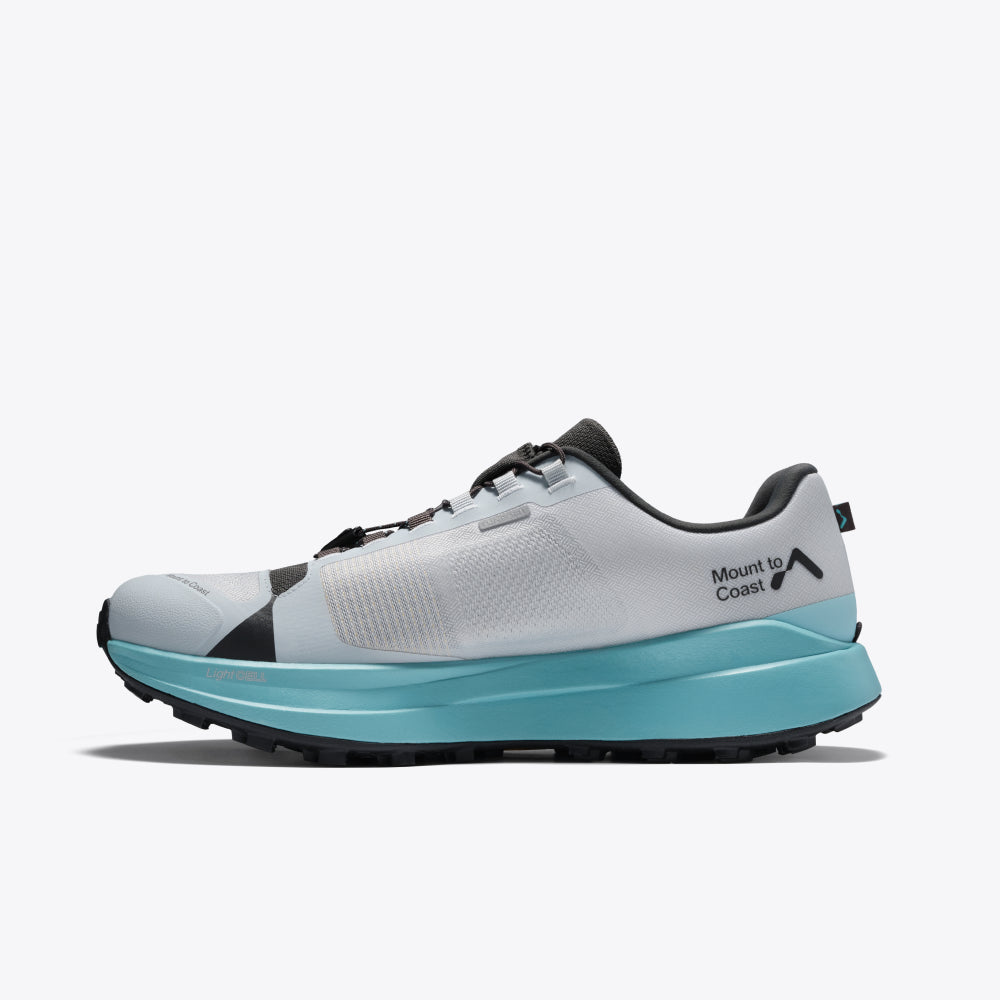 Mount to Coast T1 trail running shoe with light gray upper, teal midsole, and black outsole for trail performance.
