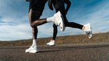 A sequence of running strides showing white athletic shoes striking the pavement.